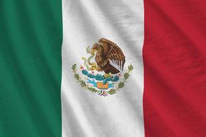 Mexico flag with big folds waving close up under the studio light indoors. The official symbols and colors in banner photo