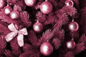 Detailed photo of the Christmas tree Image toned in Viva Magenta, color of the 2023 year