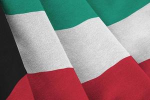 Kuwait flag with big folds waving close up under the studio light indoors. The official symbols and colors in banner photo