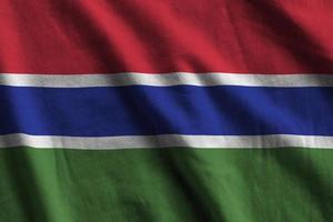 Gambia flag with big folds waving close up under the studio light indoors. The official symbols and colors in banner photo