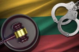 Lithuania flag with judge mallet and handcuffs in dark room. Concept of criminal and punishment, background for judgement topics photo