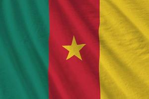 Cameroon flag with big folds waving close up under the studio light indoors. The official symbols and colors in banner photo