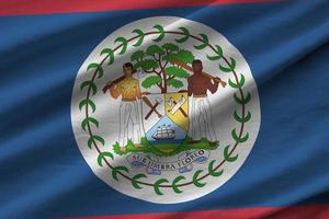 Belize flag with big folds waving close up under the studio light indoors. The official symbols and colors in banner photo