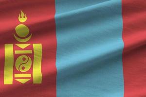 Mongolia flag with big folds waving close up under the studio light indoors. The official symbols and colors in banner photo