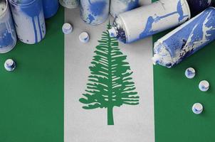 Norfolk island flag and few used aerosol spray cans for graffiti painting. Street art culture concept photo