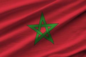 bandera de marruecos con grandes pliegues ondeando de cerca bajo la luz del estudio en el interior. los símbolos y colores oficiales en banner foto