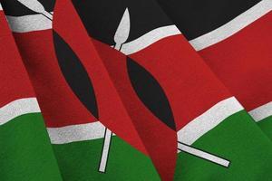Kenya flag with big folds waving close up under the studio light indoors. The official symbols and colors in banner photo