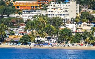 Puerto Escondido Oaxaca Mexico 2022 Sun beach people waves and boats in Puerto Escondido Mexico. photo