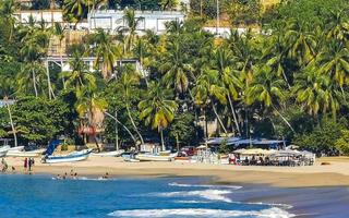 Puerto Escondido Oaxaca Mexico 2022 Sun beach people waves and boats in Puerto Escondido Mexico. photo