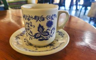 Blue white cup pot with black coffee wooden table Mexico. photo