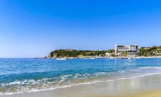 Beach sand blue water huge surfer waves Puerto Escondido Mexico. photo