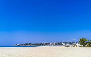 Sun beach people waves and boats in Puerto Escondido Mexico. photo