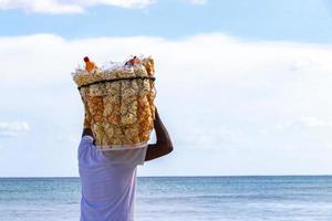 Beach vendor with food box on head in Mexico. photo