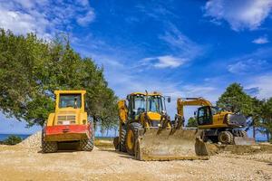 day view of stopped industry vehicles at the construction site photo