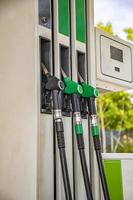 Gasoline column for refueling. Close Up guns for refueling at a gas station photo