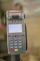 card payment terminal POS terminal at a shop, close up. Blurred background photo