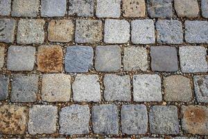 Stone pavement texture. Granite cobblestoned abstract background. Horizontal. Close-up photo