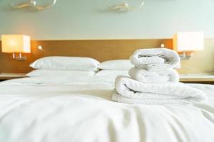 close-up white towel on bed photo