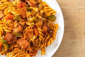 fusilli pasta with ham and tomatoes sauce photo