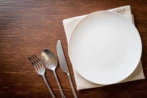 empty plate or dish with knife, fork and spoon photo