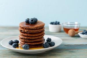 chocolate pancake stack with blueberry and honey photo