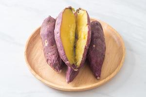 Grilled or baked Japanese sweet potatoes on wood plate photo