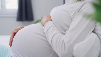 Pregnant women use hand touch on stomach during 7 months of pregnancy. Patting the belly while pregnant is a common gesture of gestures to capture the reactions of the unborn child. video