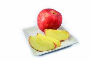 fresh red apple slice on white plate isolated on white background photo