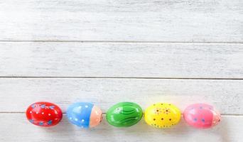 Easter eggs colorful decoration on white wooden background top view copy space photo