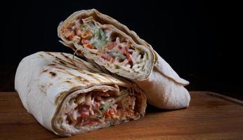 The cut shawarma lies on a wooden board. photo