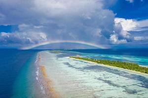 Aerial view of summer travel destination. Design of summer vacation holiday concept. Perfect aerial tranquil beach scene, soft sunlight and white sand and blue endless sea as tropical landscape photo