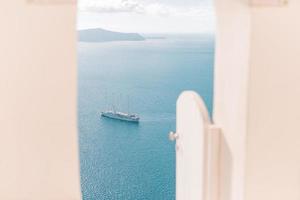 Luxury hotel entrance with white architecture on Santorini island, Greece. Beautiful landscape, sea view photo