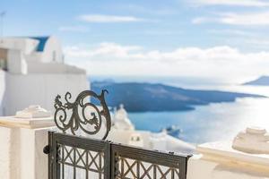 Luxury hotel entrance with white architecture on Santorini island, Greece. Beautiful landscape, sea view photo