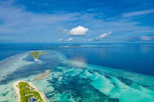 Aerial view of summer travel destination. Design of summer vacation holiday concept. Perfect aerial tranquil beach scene, soft sunlight and white sand and blue endless sea as tropical landscape photo