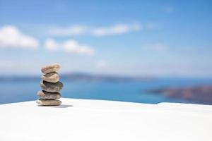 Zen stones on beautiful white wooden ground against blue sky. Dreamy scenery, inspirational nature concept. Nature balance and pattern with copy space photo