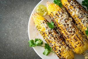 barbecue and grilled corn with cheese and lime photo