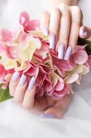 Girl's hands with a soft purple manicure. photo