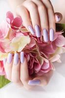 Girl's hands with a soft purple manicure. photo