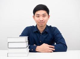 Asian man confident looking at camera with the books on the table photo