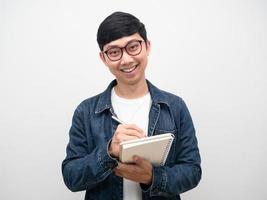 Portrait asian man wearing glasses jeans shirt smile holding dairy isolated photo
