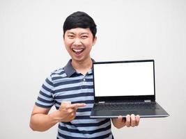 Young man striped shirt satisfied holding laptop white screen isolated photo