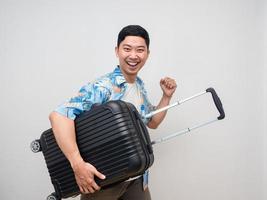 Cheerful man beach shirt hold luggage feels happy with holiday isolated photo