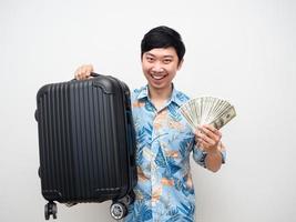 Young man beach shirt hold luggage with lot of money feels happy with holiday portrait photo