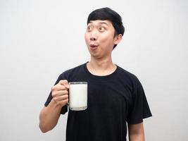 Healthy man amazed holding milk isolated photo