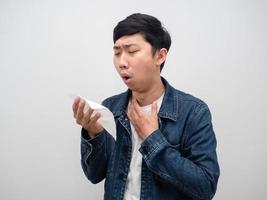 Sickness man jeans shirt cough in tissue paper,Portrait asian man cough photo