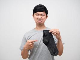 Man feels smelly point at dirty socks isolated photo