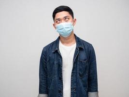 Positive man jeans shirt wear medical mask eyes cross feels doubt photo