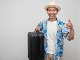 Asian man beach shirt happy smile thumb up hold luggage copy space photo