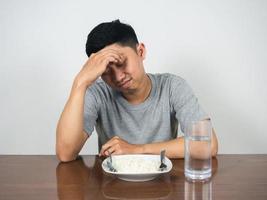 Depressed man sit with dinner on the table photo