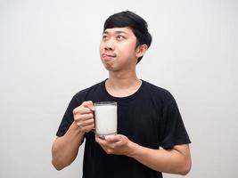 Young man holding milk gesture stick out tongue hungry food photo